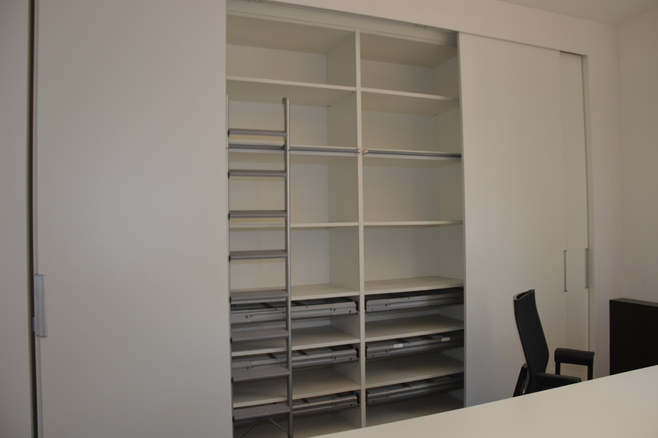 Modernes Büro mit Stauraum, Schiebetür und Arbeitsbereich.